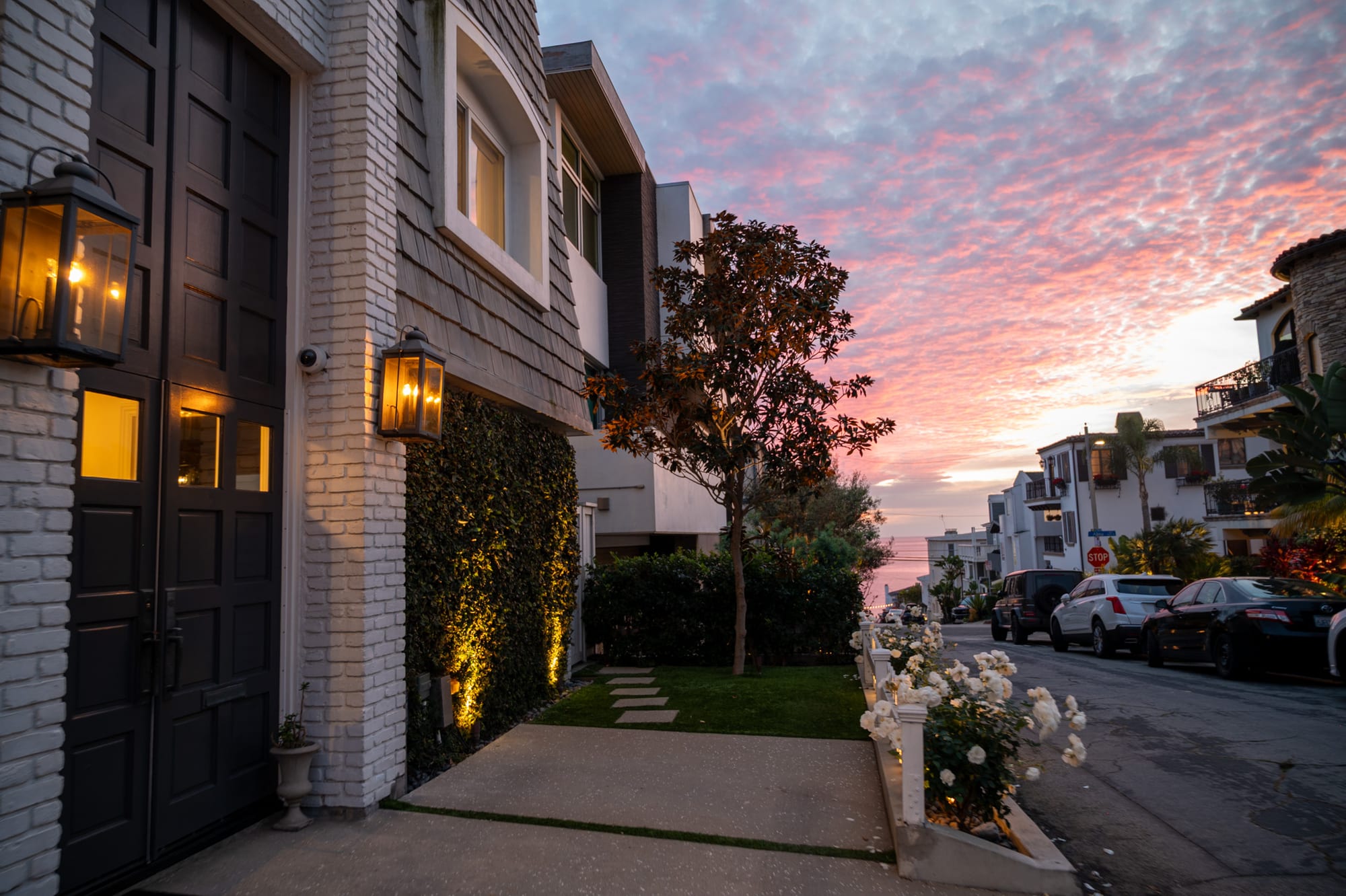 Lantern-lit entry of Manhattan Beach vacation rental at sunset