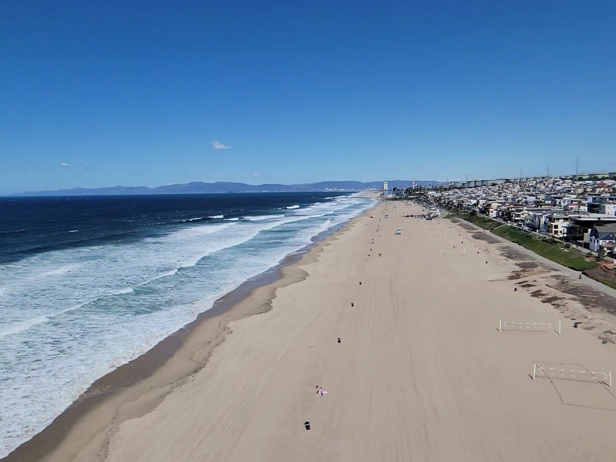 Aerial view of Manhattan Beach coastline — wide sandy beach just blocks from the property